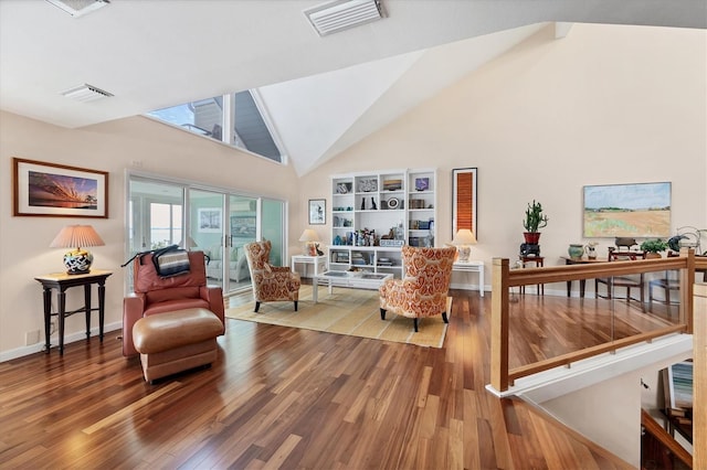 living area with hardwood / wood-style floors and vaulted ceiling