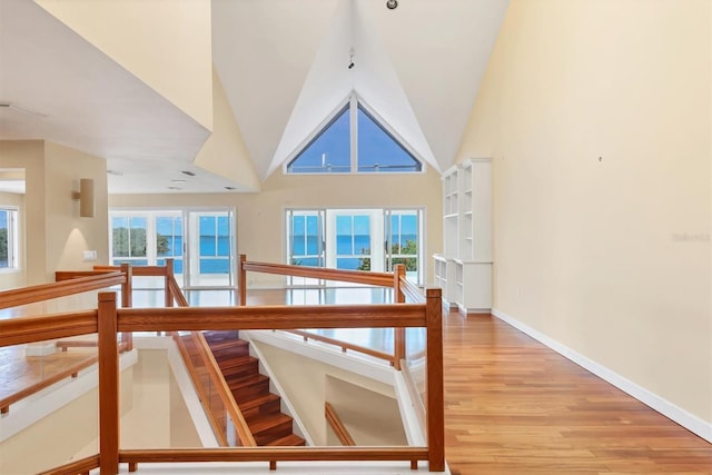 16 Tidy Island Blvd Unit 16, Bradenton, FL 34210 - hall featuring an upstairs landing, light wood-style flooring, high vaulted ceiling, and baseboards