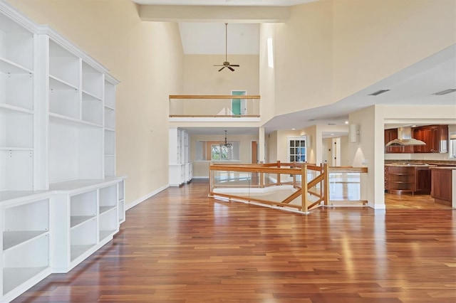 16 Tidy Island Blvd Unit 16, Bradenton, FL 34210 - unfurnished living room with wood finished floors, baseboards, a chandelier, and a towering ceiling