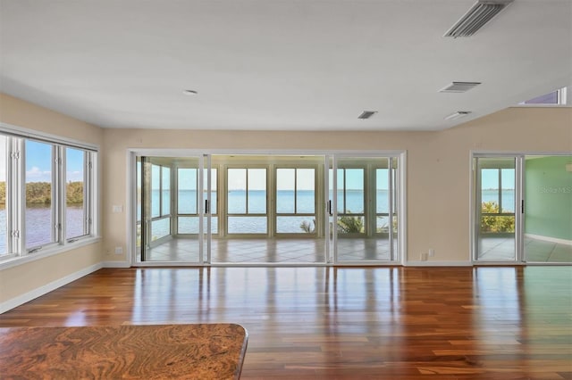 16 Tidy Island Blvd Unit 16, Bradenton, FL 34210 - unfurnished room featuring wood finished floors, plenty of natural light, and baseboards