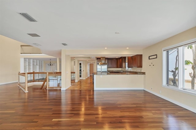 16 Tidy Island Blvd Unit 16, Bradenton, FL 34210 - unfurnished living room with dark wood-style flooring, baseboards, a sink, and recessed lighting