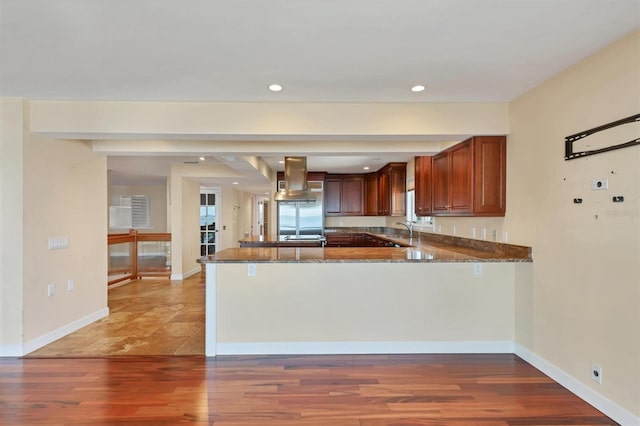 16 Tidy Island Blvd Unit 16, Bradenton, FL 34210 - kitchen featuring island range hood, a peninsula, dark stone counters, light wood finished floors, and recessed lighting