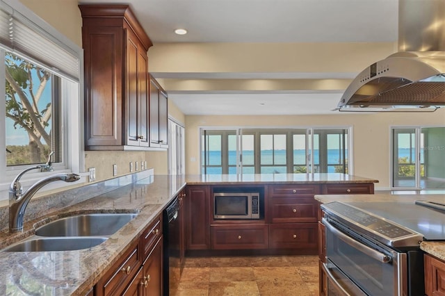 16 Tidy Island Blvd Unit 16, Bradenton, FL 34210 - kitchen featuring appliances with stainless steel finishes, a sink, island range hood, light stone countertops, and recessed lighting
