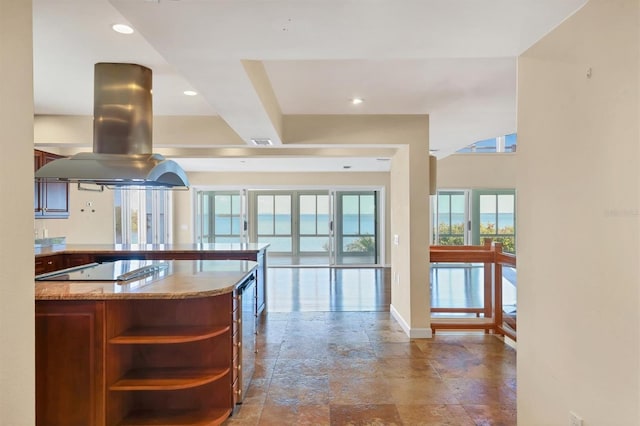 16 Tidy Island Blvd Unit 16, Bradenton, FL 34210 - kitchen with island range hood, black electric stovetop, open shelves, a peninsula, and baseboards