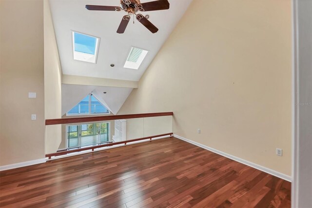 16 Tidy Island Blvd Unit 16, Bradenton, FL 34210 - unfurnished living room featuring a ceiling fan, high vaulted ceiling, wood finished floors, a skylight, and baseboards