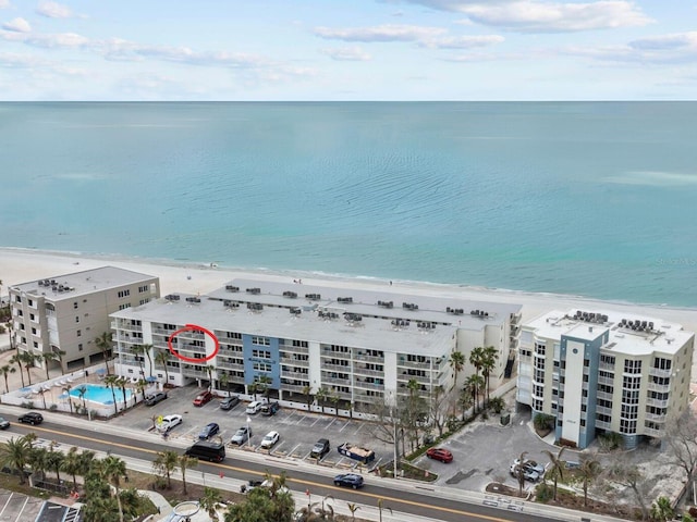 birds eye view of property with a view of the beach and a water view