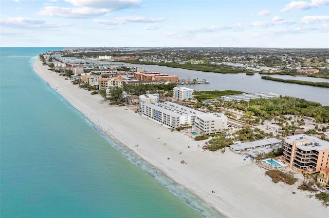 drone / aerial view featuring a water view and a beach view