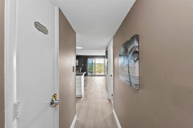 hallway with light hardwood / wood-style flooring