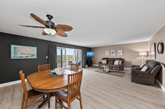 dining space featuring light wood-type flooring and ceiling fan