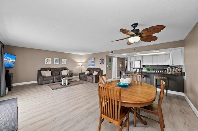 dining room featuring ceiling fan and light wood-type flooring