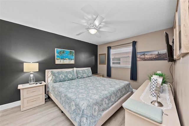 bedroom with ceiling fan and light hardwood / wood-style flooring