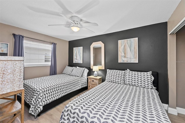 bedroom featuring a closet, hardwood / wood-style flooring, and ceiling fan