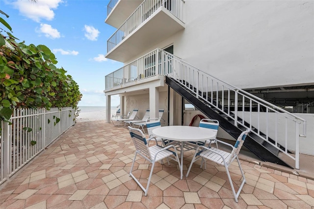 view of patio featuring a water view and a view of the beach