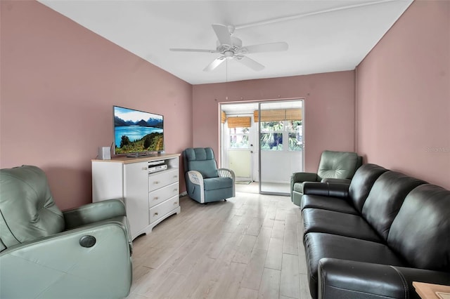 living room featuring light hardwood / wood-style flooring and ceiling fan