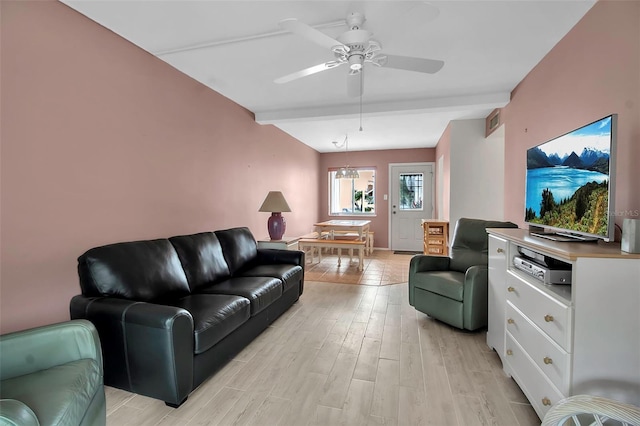 living room featuring beam ceiling, ceiling fan with notable chandelier, and light hardwood / wood-style flooring