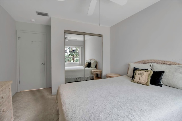 carpeted bedroom with a closet and ceiling fan