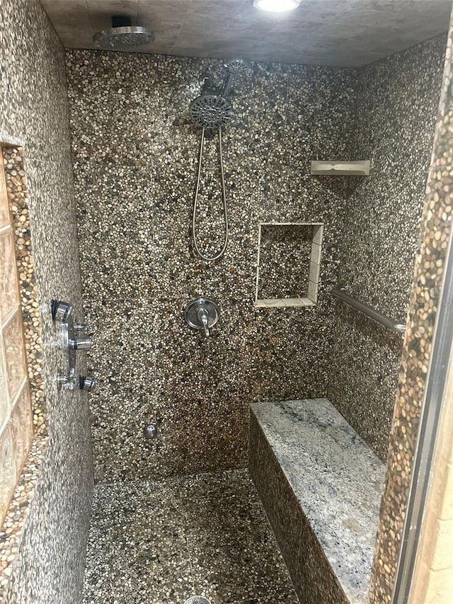 bathroom with a tile shower