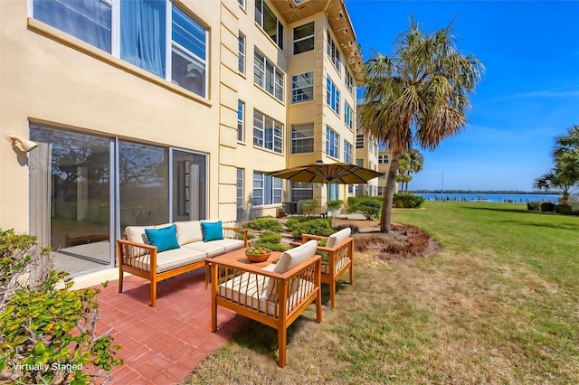 view of patio / terrace featuring outdoor lounge area and a water view