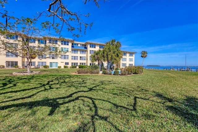 view of community featuring a yard and a water view