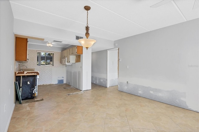 unfurnished living room featuring ceiling fan