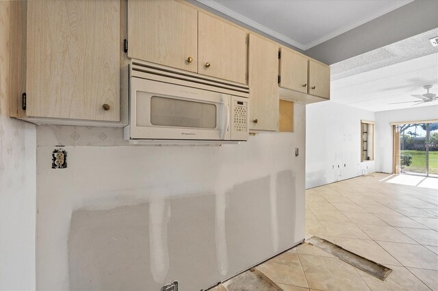 kitchen featuring ceiling fan, ornamental molding, light tile patterned floors, and light brown cabinetry