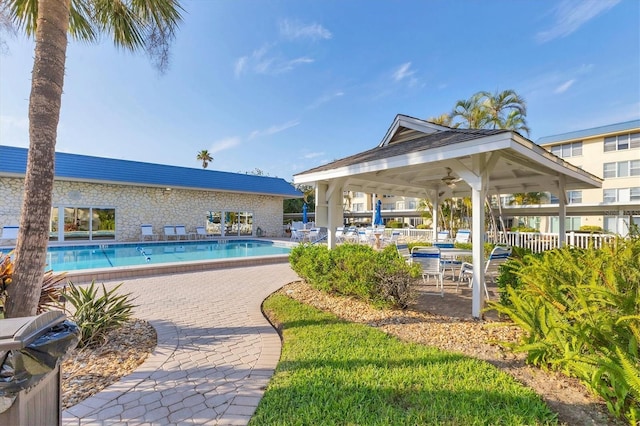 view of pool with a gazebo, area for grilling, ceiling fan, and a patio