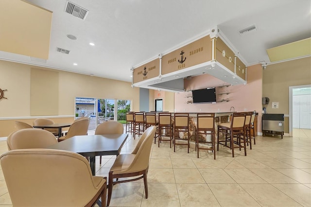 tiled dining space with ornamental molding