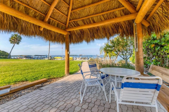 view of patio with a gazebo and a water view