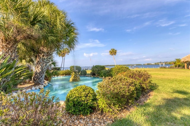 exterior space featuring a yard and a water view