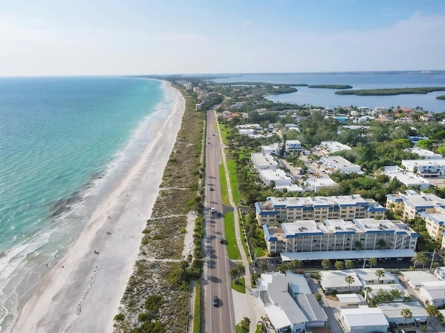 drone / aerial view featuring a water view and a view of the beach