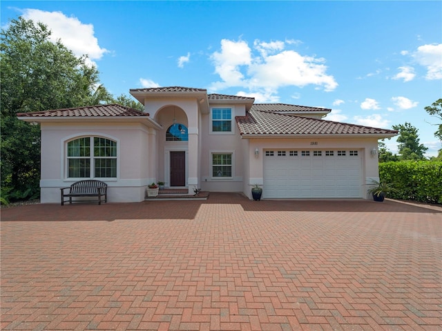 mediterranean / spanish house with a garage