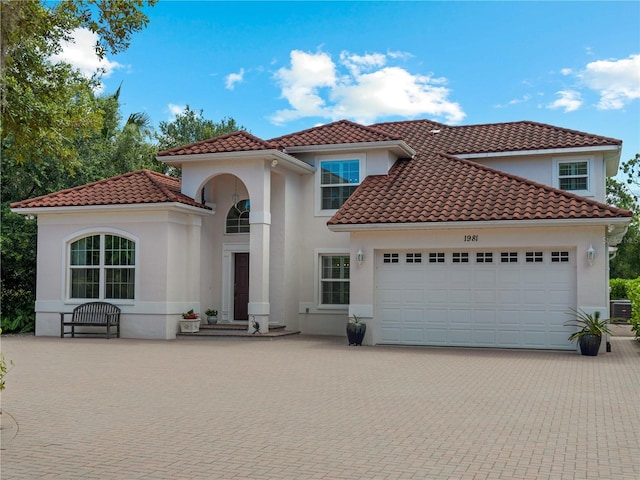 mediterranean / spanish house featuring a garage