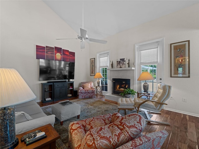 living room featuring ceiling fan, dark hardwood / wood-style flooring, and vaulted ceiling