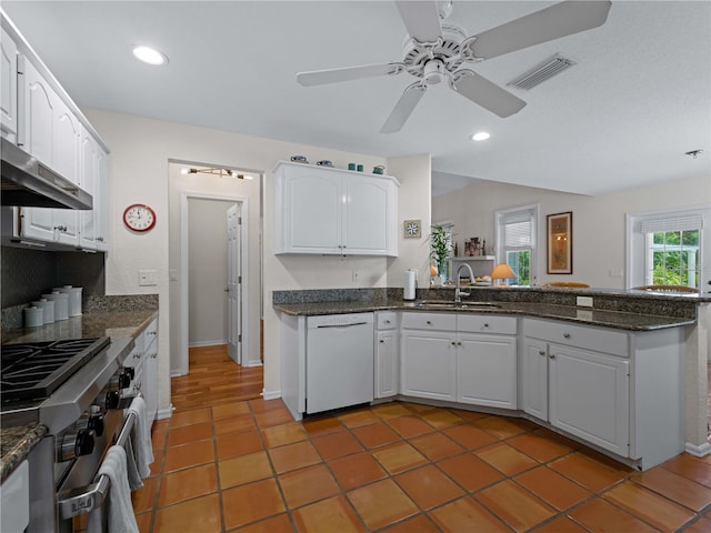 kitchen featuring white cabinetry, sink, white dishwasher, and high end stainless steel range oven