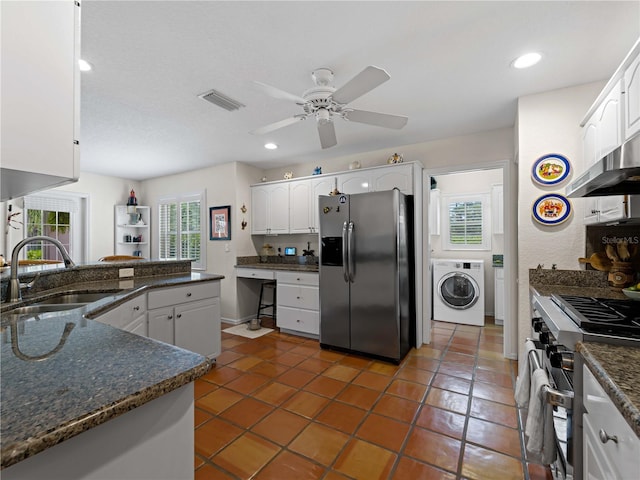 kitchen featuring ceiling fan, sink, stainless steel appliances, washer / clothes dryer, and white cabinets