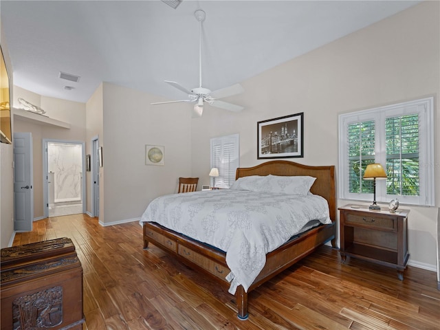 bedroom with connected bathroom, ceiling fan, and wood-type flooring