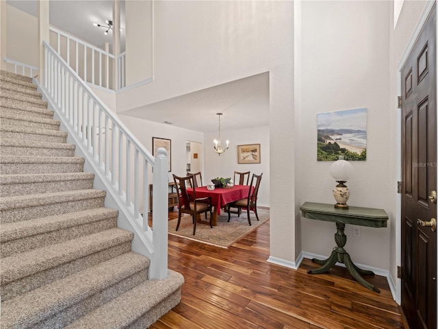 foyer with dark hardwood / wood-style flooring and an inviting chandelier