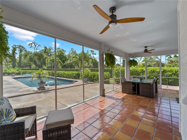 sunroom / solarium featuring ceiling fan