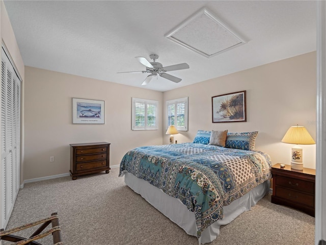 bedroom featuring ceiling fan, light colored carpet, and a closet