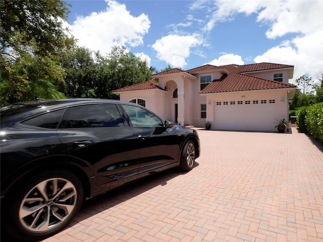 mediterranean / spanish home with a garage