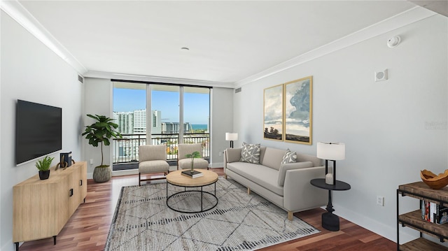 living room featuring wood-type flooring, ornamental molding, and floor to ceiling windows