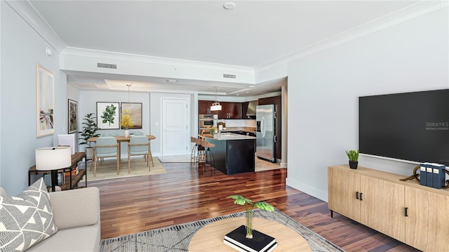 living room featuring ornamental molding, dark hardwood / wood-style floors, and sink