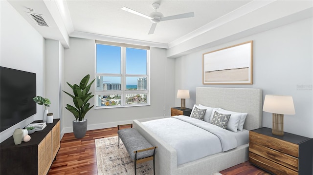 bedroom with ceiling fan, ornamental molding, and dark hardwood / wood-style flooring