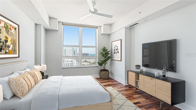 bedroom with dark hardwood / wood-style flooring and ceiling fan