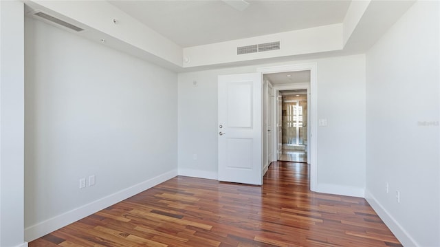 spare room with dark wood-type flooring