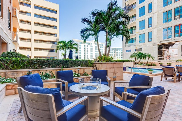 view of patio featuring a community pool and an outdoor fire pit