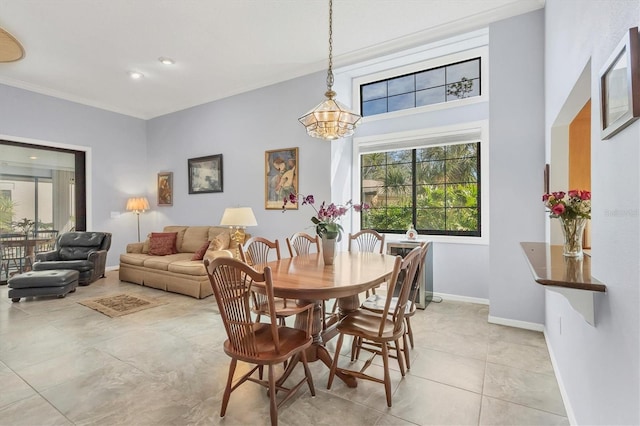 tiled dining room featuring ornamental molding