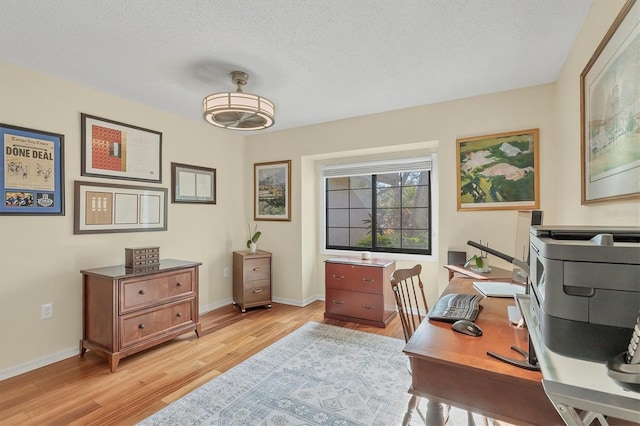 office area featuring light hardwood / wood-style flooring and a textured ceiling