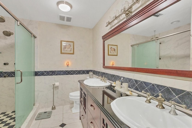 bathroom featuring tile walls, an enclosed shower, vanity, tile patterned floors, and toilet