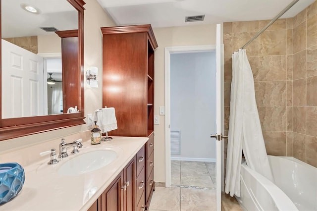 bathroom featuring vanity and shower / bath combination with curtain